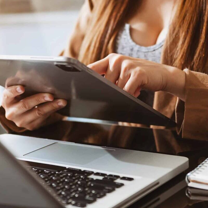 Working Process in Modern Office. Young Woman Account Manager Working at Wood Table with New Business Project. Working Process In Modern Office. Young Woman Account Manager Working At Wood Table With New Business Project. Typing Keyboard,Using Contemporary Laptop. Horizontal.