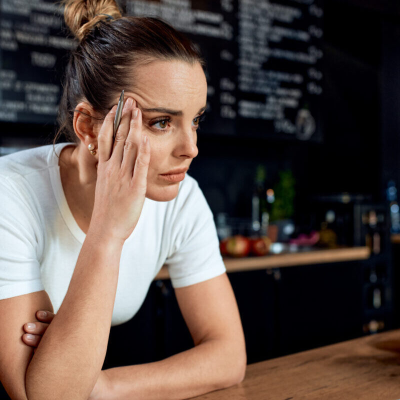 Frustrated small business owner in closed cafe Frustrated small business owner in closed cafe