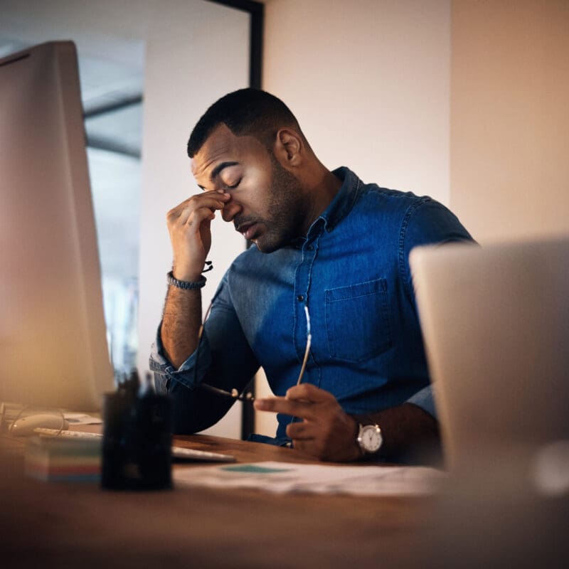 Headache, Eye Strain And Businessman In The Office At Night Working On Deadline Project. Burnout, Stress And Professional Male Employee With Migraine Doing Research On Computer Overtime In Workplace