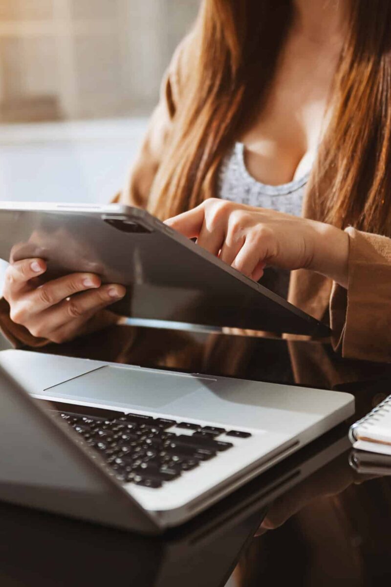 Working Process in Modern Office. Young Woman Account Manager Working at Wood Table with New Business Project. Working Process in Modern Office. Young Woman Account Manager Working at Wood Table with New Business Project. Typing keyboard,Using Contemporary Laptop. Horizontal.