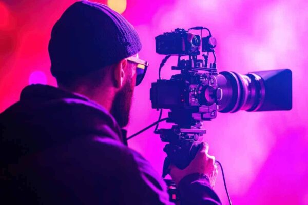 Photographer Capturing Stunning Live Performance with Professional Camera in Vibrant Neon Atmosphere